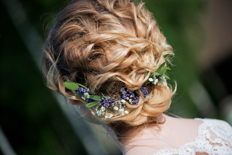 The bride is preparing for the wedding. Beautiful hairstyle with a hoop. Back of the head.