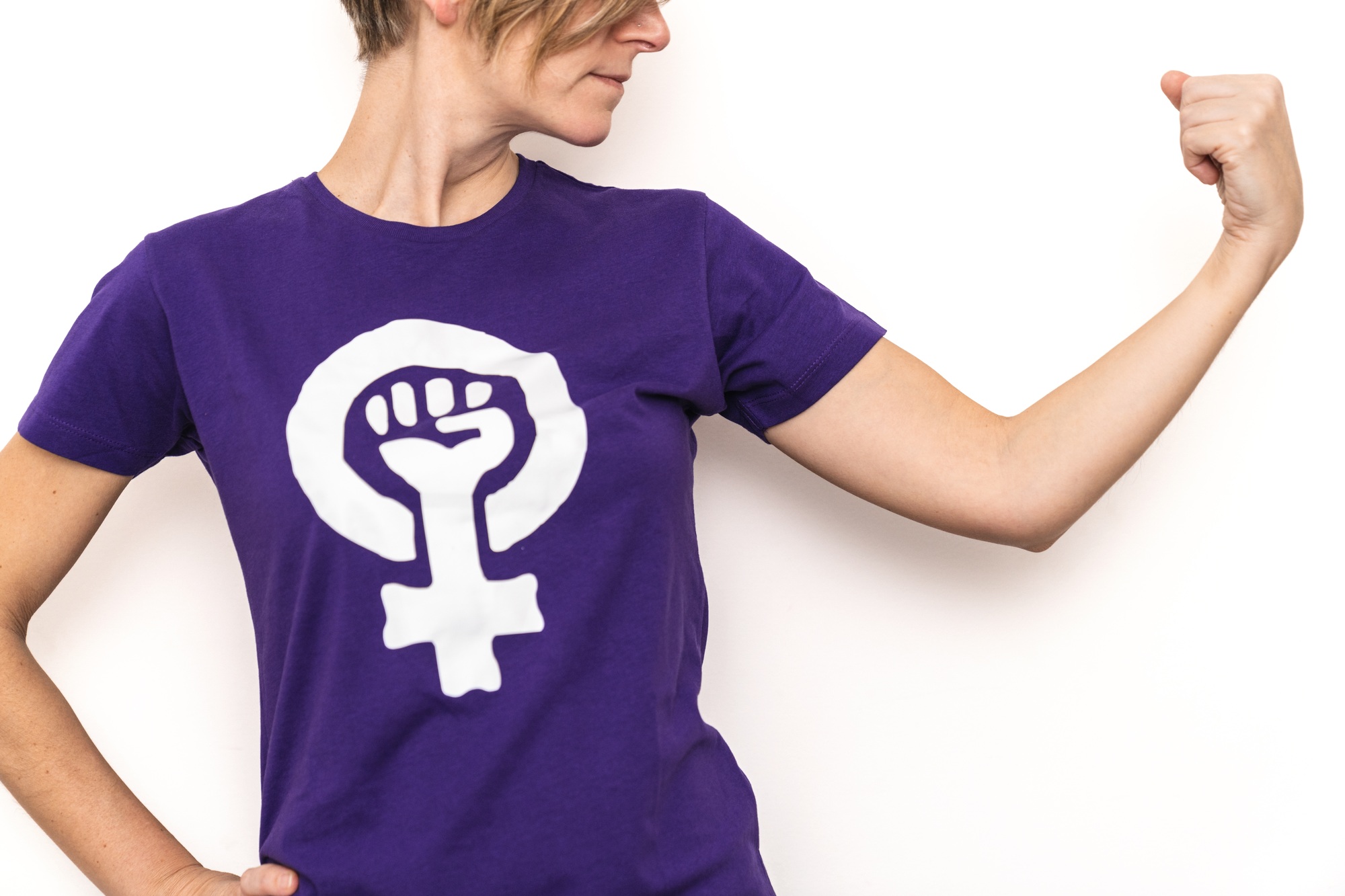 Woman showing strength and feminist symbol on t shirt for women's day