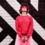 Hipster fashio woman in trendy viva magenta color sweatshirt and sunglasses. Color of 2023 year.